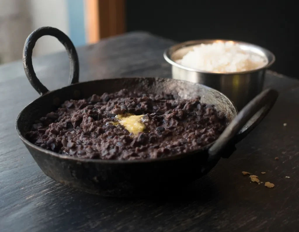 Chainsoo - dark roasted black gram dal cooked in an iron pot