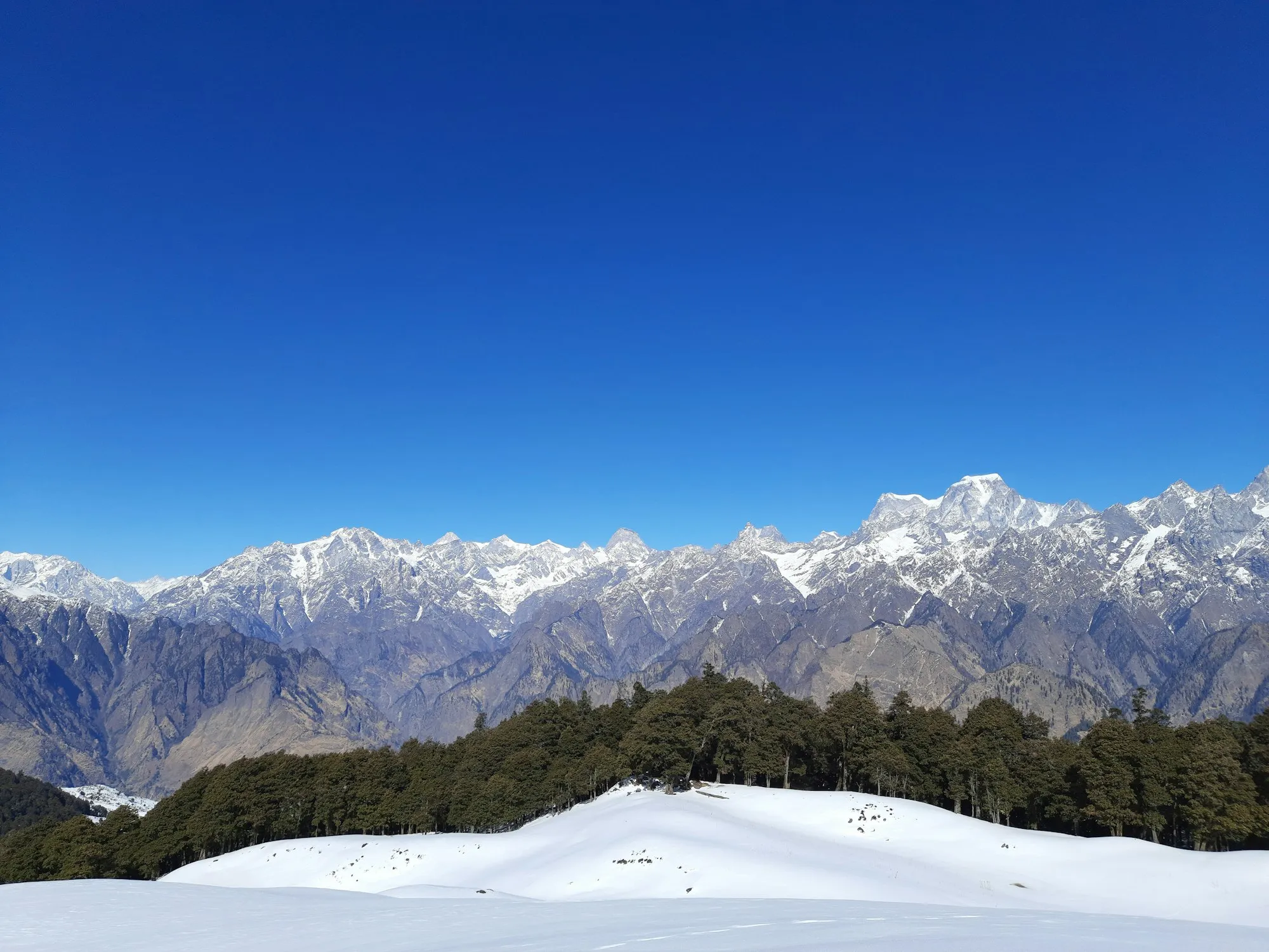 Snow-capped Himalayan peak seen from Auli under a blue sky