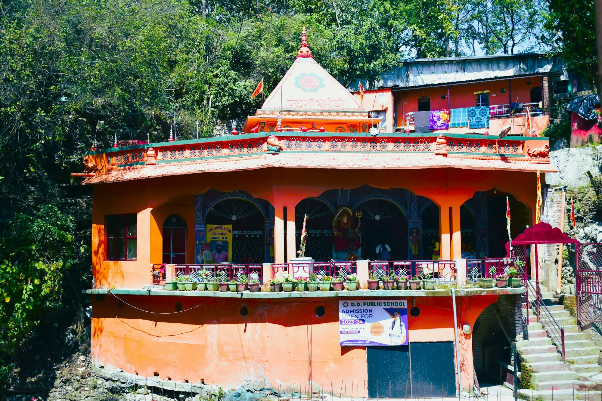 Saffron-painted building of Tapkeshwar Mahadev Temple in Dehradun (photo: Abhishek Royal, Unsplash)